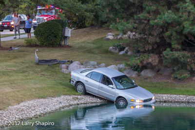 Arlington Heights FD IL MVA crash with no injuries car into a pond Schoenbeck Road and East Towne Boulevard 9-15-17 shapirophotography.net #larryshapiro Larry Shapiro photographer